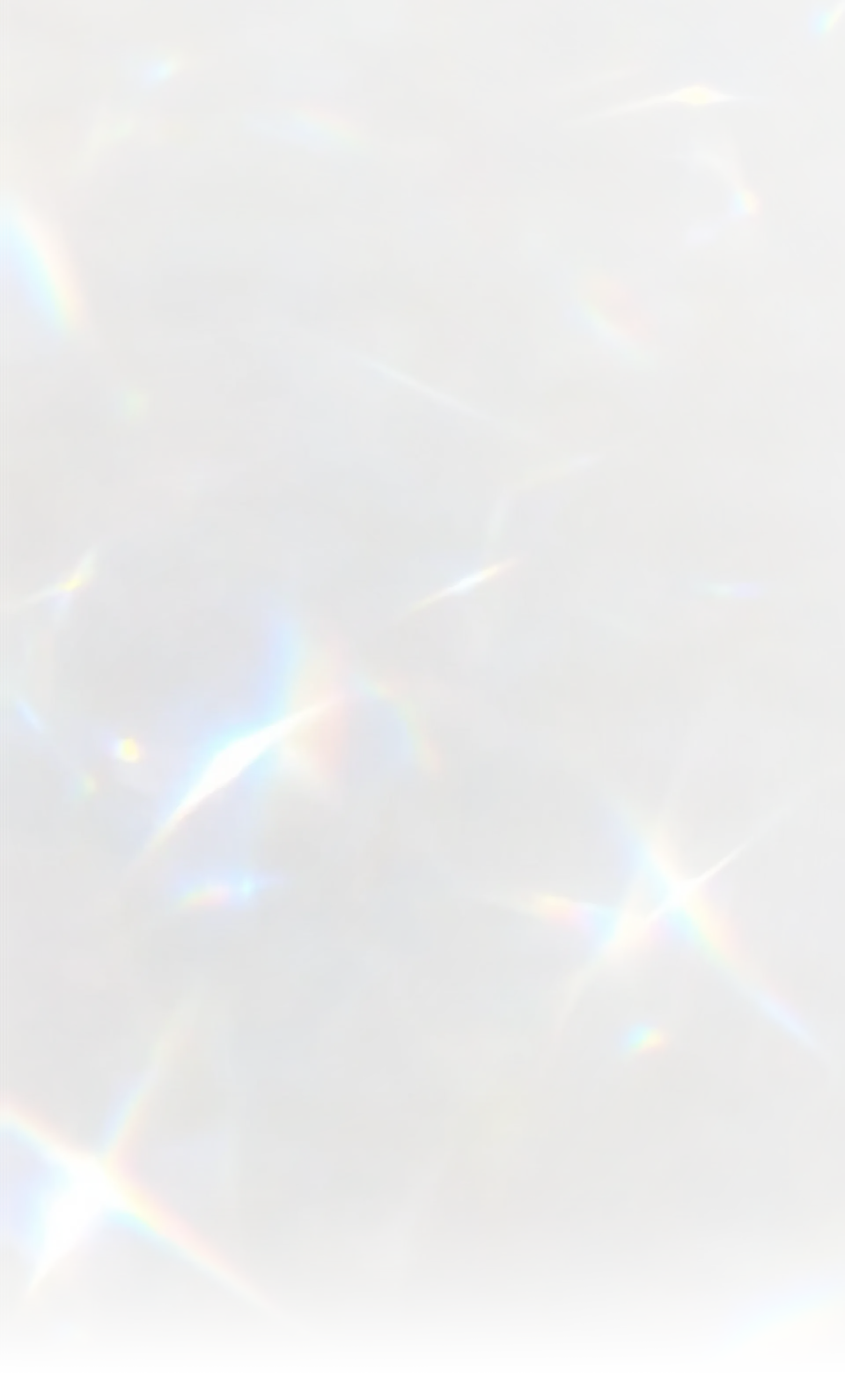 Soft blurred light flares with subtle rainbow colors against a pale background.
